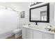 Bathroom featuring white vanity with a vessel sink, black faucet, and framed mirror at 12445 N 42Nd Dr, Phoenix, AZ 85029