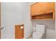 Small bathroom with toilet and wood shelving at 1321 E Bayview Dr, Tempe, AZ 85283