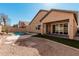 Stunning backyard with pool, gravel landscaping, and covered patio, perfect for outdoor living at 13550 W Port Au Prince Ln, Surprise, AZ 85379