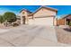 Charming single-story home featuring a three-car garage and long driveway at 13550 W Port Au Prince Ln, Surprise, AZ 85379