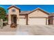 Charming single-story home featuring a three-car garage and desert landscaping at 13550 W Port Au Prince Ln, Surprise, AZ 85379