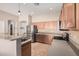 Kitchen with stainless steel appliances, tile backsplash, and ample cabinet space at 13550 W Port Au Prince Ln, Surprise, AZ 85379