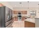 Kitchen featuring stainless steel appliances, tile floors, and ample cabinet space at 13550 W Port Au Prince Ln, Surprise, AZ 85379