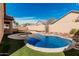 Backyard oasis with a refreshing pool, artificial grass, and block wall at 13550 W Port Au Prince Ln, Surprise, AZ 85379