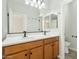 Bathroom with double sinks, wood cabinets, and a shower at 1381 W Birch Rd, Queen Creek, AZ 85140