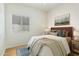 Bedroom with a queen-sized bed and wood floors at 1381 W Birch Rd, Queen Creek, AZ 85140