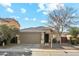 Beige house with a two-car garage and landscaping at 1381 W Birch Rd, Queen Creek, AZ 85140