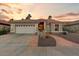 Single-story home with a terracotta tile roof, landscaped yard, and two-car garage at 15695 W Earll Dr, Goodyear, AZ 85395