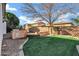 This backyard features an outdoor kitchen, built-in seating, and a patch of artificial grass at 1612 E Zion Way, Chandler, AZ 85249