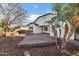 A backyard features a grilling station, outdoor seating, and mature palm trees at 1612 E Zion Way, Chandler, AZ 85249