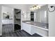 Spacious bathroom featuring a large vanity with double mirrors and walk-in closet with custom storage at 1612 E Zion Way, Chandler, AZ 85249