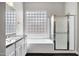 Bright bathroom featuring a shower with glass door and large window above the tub at 1612 E Zion Way, Chandler, AZ 85249