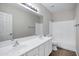 A well-lit bathroom features double sinks, a large mirror, and a shower-tub combo at 1612 E Zion Way, Chandler, AZ 85249