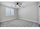 A cozy bedroom features plush carpet, a ceiling fan, and bright natural light from window shutters at 1612 E Zion Way, Chandler, AZ 85249