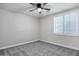 A serene bedroom offers neutral walls, a ceiling fan, and soft carpeting at 1612 E Zion Way, Chandler, AZ 85249
