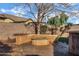 A cozy backyard is centered around a gas fire pit surrounded by a low seating wall at 1612 E Zion Way, Chandler, AZ 85249