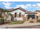 Charming home featuring stone accents, manicured lawn, tile roof, and a two-car garage at 1612 E Zion Way, Chandler, AZ 85249