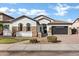 Inviting single-story home with stone accents, tile roof, well-manicured lawn, and paver driveway at 1612 E Zion Way, Chandler, AZ 85249