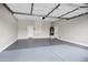 A spacious garage boasts an epoxy floor, ample storage space, and access doors at 1612 E Zion Way, Chandler, AZ 85249