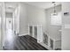 Bright hallway with hardwood floors, white trim, and decorative railing leading to the upper level at 1612 E Zion Way, Chandler, AZ 85249