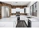 Bright kitchen showcasing stone wall, stainless steel appliances, white cabinets and countertop space at 1612 E Zion Way, Chandler, AZ 85249