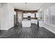 Spacious kitchen with stone accent wall, white cabinets, stainless steel appliances, and center island at 1612 E Zion Way, Chandler, AZ 85249