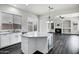 Modern kitchen with white cabinets, quartz countertops, stainless steel appliances, and an island at 1612 E Zion Way, Chandler, AZ 85249