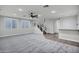 Open floor plan features stairs, built-in bar, ceiling fan, and neutral carpeting at 1612 E Zion Way, Chandler, AZ 85249