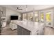 White kitchen island with seating, open to living room, offering an airy feel at 1720 E Redwood Pl, Chandler, AZ 85286