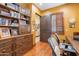 A home office featuring wooden floors, built-in shelves, and a beautiful wooden desk at 1777 W Ocotillo Rd # 6, Chandler, AZ 85248