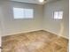 Spacious bedroom with tile floors and large window at 1816 E Palmcroft Dr, Tempe, AZ 85282