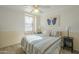 Bedroom with ceiling fan and striped bedding at 19882 S 198Th St, Queen Creek, AZ 85142