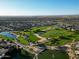 Aerial view of community with golf course and lake at 20309 N Windy Walk Ct, Surprise, AZ 85374