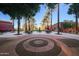 Circular patio with tables, umbrellas, and palm trees at 20309 N Windy Walk Ct, Surprise, AZ 85374