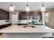 Modern kitchen with dark cabinets and quartz countertops at 2056 W El Cortez Trl, Phoenix, AZ 85085