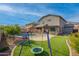 Landscaped backyard with grassy area, swing set, and pool at 21269 W Haven Dr, Buckeye, AZ 85396