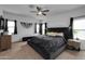 Main bedroom with plush bed and large windows at 21269 W Haven Dr, Buckeye, AZ 85396