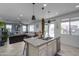 Kitchen island with sink overlooking Gathering room and pool at 21269 W Haven Dr, Buckeye, AZ 85396