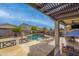 Covered patio with outdoor kitchen, pergola, and pool access at 21269 W Haven Dr, Buckeye, AZ 85396