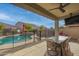Covered patio with seating area, ceiling fan, and views of the pool at 21269 W Haven Dr, Buckeye, AZ 85396