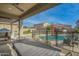 Outdoor patio with large dining table, pool view, and built-in BBQ at 21269 W Haven Dr, Buckeye, AZ 85396