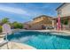 Inviting backyard pool with safety fence, waterfall feature, and spacious patio at 21269 W Haven Dr, Buckeye, AZ 85396