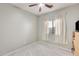 Simple bedroom with ceiling fan and window at 21499 N Greenland Park Dr, Maricopa, AZ 85139