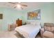 Bedroom with ceiling fan, dresser and recliner at 21499 N Greenland Park Dr, Maricopa, AZ 85139