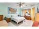 Light and airy bedroom with wood dresser and ceiling fan at 21499 N Greenland Park Dr, Maricopa, AZ 85139