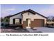 Single-story home with Spanish-style architecture, two-car garage, and landscaping at 22665 W Irma Ln, Surprise, AZ 85387
