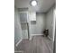 Small laundry room with vinyl flooring and wall mounted HVAC unit at 245 S 56 St # 174, Mesa, AZ 85206