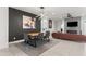 Dining area with a rustic wooden table and modern lighting at 2826 N 28Th Pl, Phoenix, AZ 85008