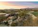 Aerial view of house and golf course with mountain backdrop at 34587 N Ironwood Rd, Scottsdale, AZ 85266