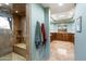 Bathroom with a large walk-in shower, tile flooring, and a built-in bench at 34587 N Ironwood Rd, Scottsdale, AZ 85266